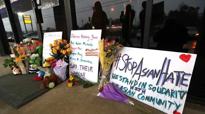 A memorial grows larger by the hour outside Young’s Asian Massage, where four people were killed on Wednesday, March 17, 2021, in Acworth. At least eight people were found dead at three different spas in the Atlanta area March 16. Robert Aaron Long, 21, was charged in the shooting spree, which began at Young’s Asian Massage. (Curtis Compton / Curtis.Compton@ajc.com)