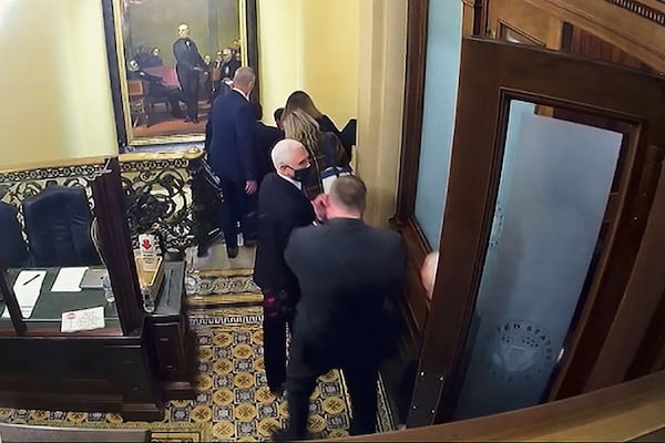 FILE - In this image from video, a security video shows Vice President Mike Pence being evacuated from near the Senate chamber as rioters breach the Capitol, on Jan. 6, 2021, at the Capitol in Washington. (Senate Television via AP, File)