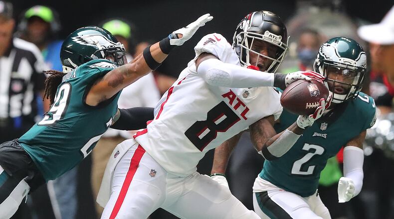Falcons rookie tight end Kyle Pitts makes a reception against a double team by Philadelphia Eagles defenders during the fourth quarter Sunday, Sept. 12, 2021, at Mercedes-Benz Stadium in Atlanta. (Curtis Compton / Curtis.Compton@ajc.com)