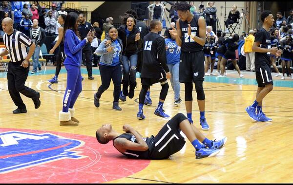 Westlake Lions head coach Darron Rogers (left) and the Westlake Lions hold the trophy and game ball in the win over the Pebblebrook Falcons in the Class AAAAAA boys championship at the Macon Coliseum Saturday, March 5, 2016. The Westlake Lions beat the Pebblebrook Falcons, 68-58 for the championship. KENT D. JOHNSON/ kdjohnson@ajc.com