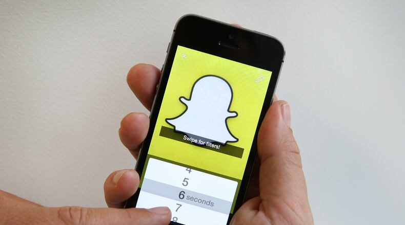 LONDON, ENGLAND - OCTOBER 06: In this photo illustration the Snapchat app is used on an iPhone on October 6, 2014 in London, England. Snapchat allows users' messages to vanish after seconds. (Photo by Peter Macdiarmid/Getty Images)