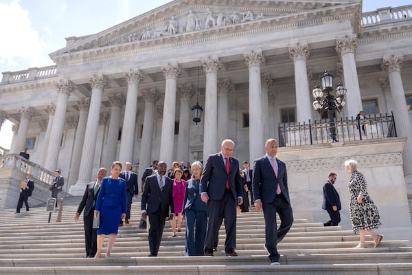 Senate Minority Leader Chuck Schumer, of N.Y., second from right, and House Minority Leader Hakeem Jeffries, of N.Y., right, arrive with other House and Senate Democrats for an event to mark 100 days of President Donald Trump's term on the steps of the Senate on Capitol Hill, Wednesday, April 30, 2025, in Washington. (AP Photo/Mark Schiefelbein)