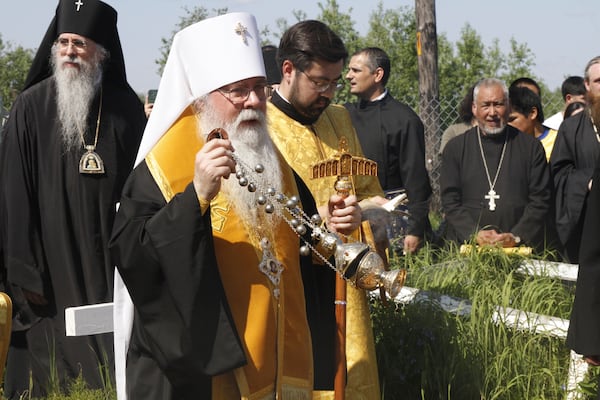 Metropolitan Tikhon, the head of the Orthodox Church in America, swings a censer as he blesses the remains of Matushka Olga Michael before a ceremony that made her the first female Orthodox saint in North America, in Kwethluk, Alaska, on June 19, 2025. (AP Photo/Mark Thiessen)