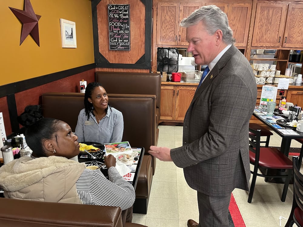 U.S. Rep. Mike Collins, R-Jackson, chatted with diners at Pot Luck Cafe in Monroe last year.