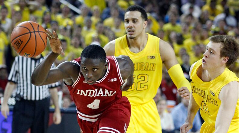 Indiana guard Victor Oladipo (4) drives to the basket while pursued by Michigan forward Jordan Morgan (52) and guard Spike Albrecht (2) during the first half of an NCAA college basketball game Sunday, March 10, 2013, in Ann Arbor, Mich. (AP Photo/Duane Burleson)