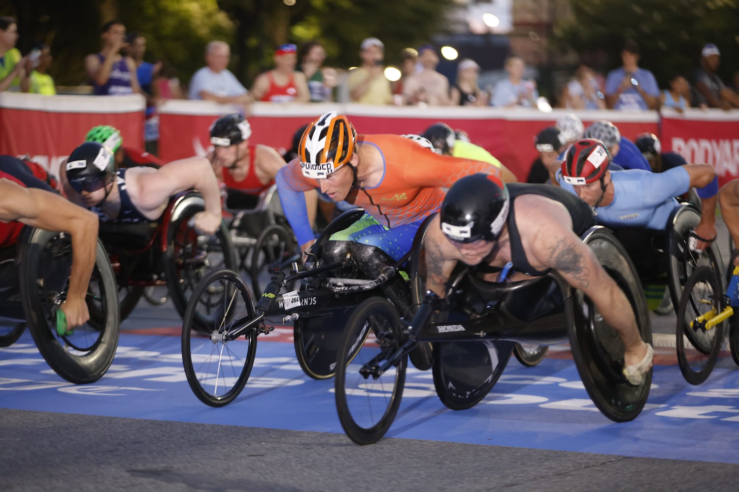 The men’s wheelchair division get in position at the start of the 56th AJC Peachtree Road Race on Friday, July 4, 2025, in Atlanta. (Arvin Temkar/AJC)