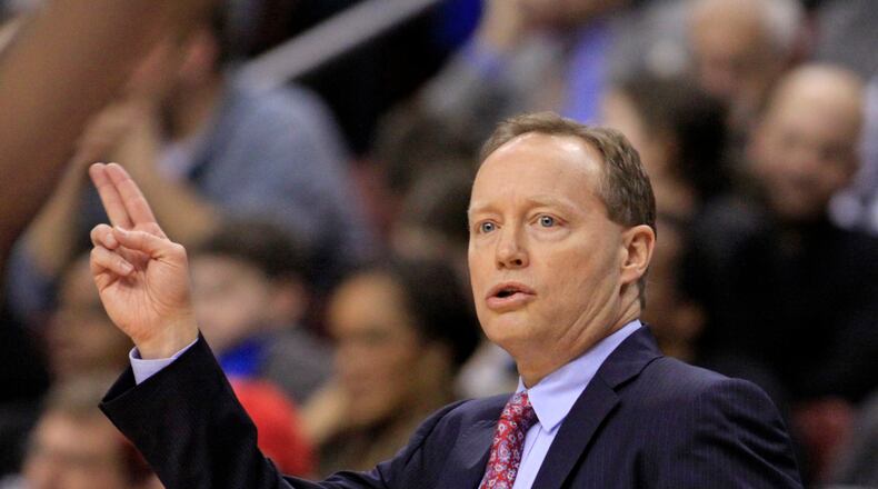 Atlanta Hawks coach Mike Budenholzer calls a play against the Philadelphia 76ers in the first half of an NBA basketball game, Friday, Jan. 31, 2014, in Philadelphia. The Hawks won 125-99. (AP Photo/H. Rumph Jr.)
