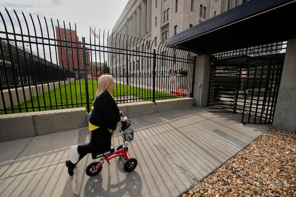 IRS customer service representative Shannon Ellis, goes to work at the processing center where hundreds of her colleagues have taken buyouts and others face potential layoffs, Monday, April 14, 2025, in Kansas City, Mo. (AP Photo/Charlie Riedel)