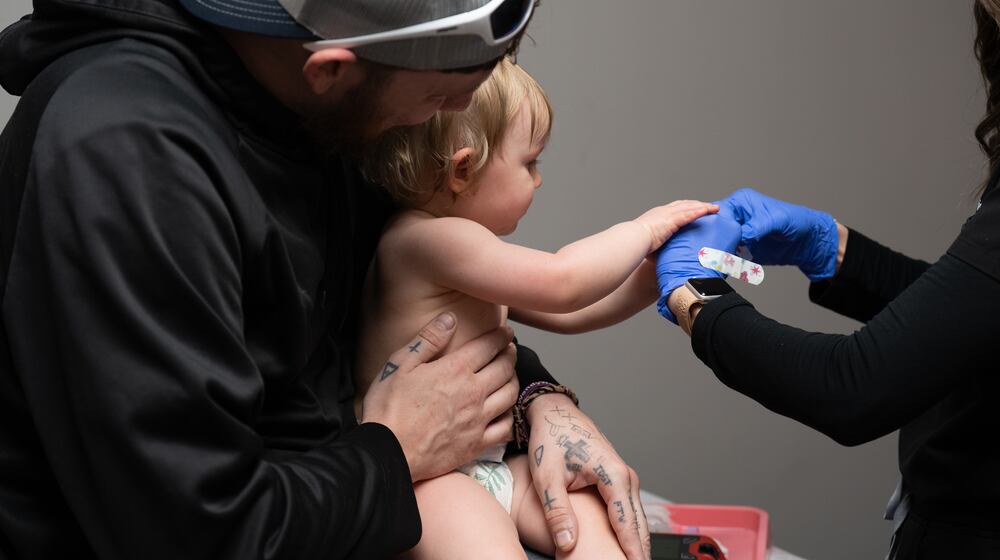 Daren Chandler's 12-month-old daughter has blood drawn before receiving a measles shot at Tiger Pediatrics in Easley, South Carolina on March 17, 2026. (Mary Conlon/AP)