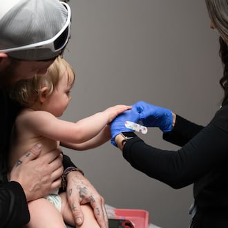 Daren Chandler's 12-month-old daughter has blood drawn before receiving a measles shot at Tiger Pediatrics in Easley, South Carolina on March 17, 2026. (Mary Conlon/AP)