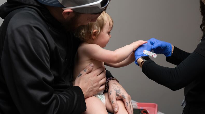 Daren Chandler's 12-month-old daughter has blood drawn before receiving a measles shot at Tiger Pediatrics in Easley, South Carolina on March 17, 2026. (Mary Conlon/AP)