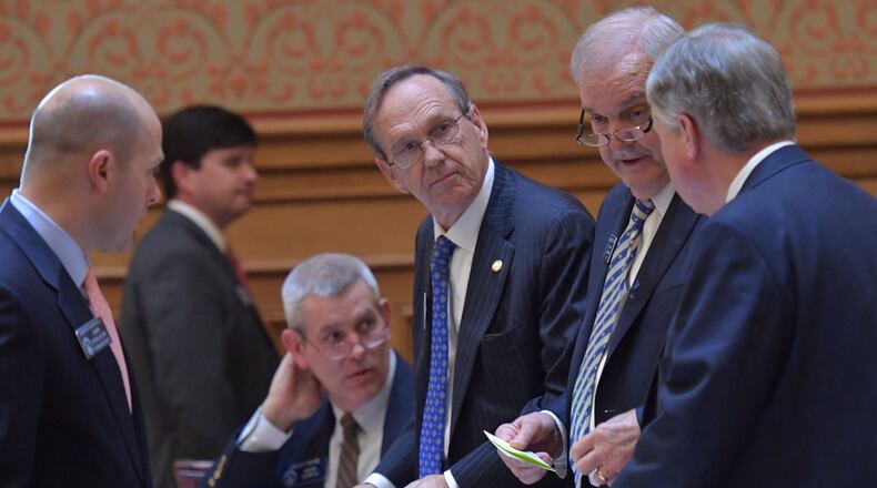 March 30, 2017 Atlanta - Sen. Larry Walker (center) confers with other senators on the senate floor on Thursday, March 30, 2017. HYOSUB SHIN / HSHIN@AJC.COM