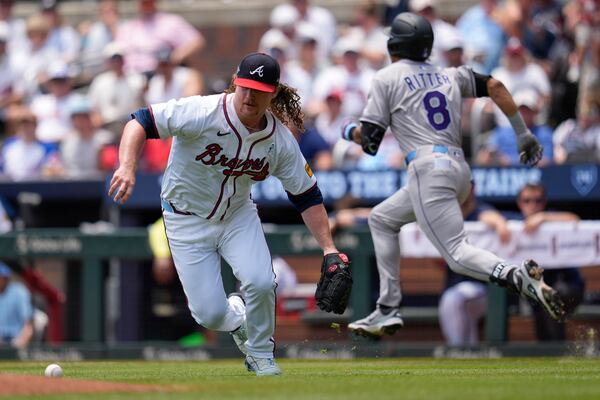 Atlanta Braves pitcher Grant Holmes (66) attempts fielding a ball hit by Colorado Rockies' Ryan Ritter (8) in the third inning of a baseball game, Sunday, June 15, 2025, in Atlanta. (AP Photo/Mike Stewart)