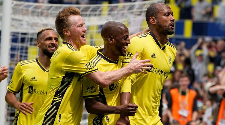 Nashville SC midfielder Dax McCarty, second from left, and midfielder Fafà Picault, center, congratulate forward Teal Bunbury after his goal against Atlanta United during the second half of an MLS soccer match on Saturday, April 29, 2023, in Nashville, Tenn. (AP Photo/George Walker IV)