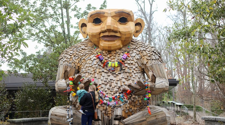 At 15 feet tall, Kamma Can is the largest of the wooden trolls now lurking in Atlanta Botanical Garden. She is festooned with jewelry she has made from discarded plastic and trash. / Courtesy of Atlanta Botanical Garden