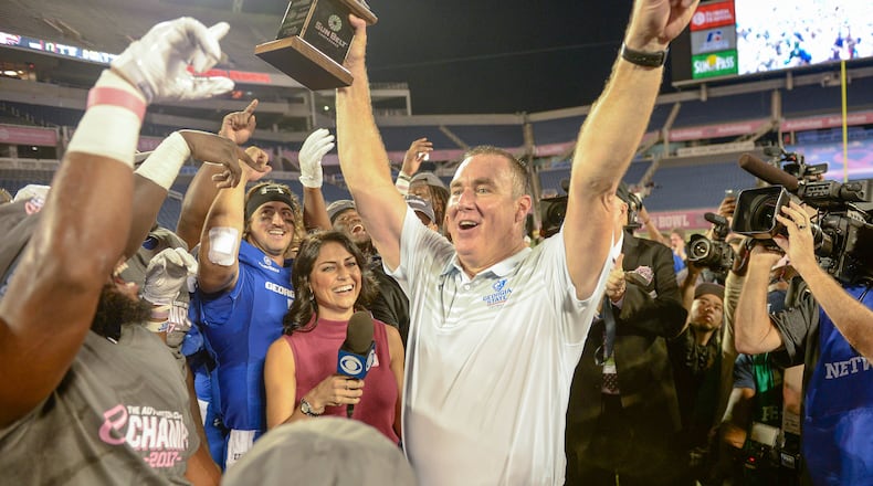 Georgia State coach Shawn Elliott holds the Cure Bowl trophy after the Panthers defeated the Western Kentucky Hilltoppers 27-17 on Dec. 16 in Orlando. It was the program's first bowl win.