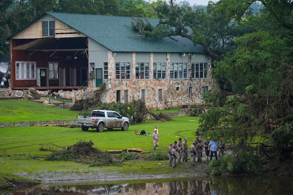 Officials search on the grounds of Camp Mystic along the banks of the Guadalupe River after a flash flood swept through the area Sunday, July 6, 2025, in Hunt, Texas. (AP Photo/Julio Cortez)