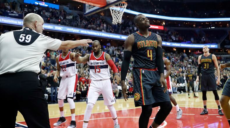 Referee Gary Zielinski (59) points to Atlanta Hawks forward Paul Millsap (4), who last touched the ball before it went out of bounds, giving the Washington Wizards the final possession of the NBA basketball game Friday, Nov. 4, 2016, in Washington. The Wizards won 95-92. (AP Photo/Alex Brandon)