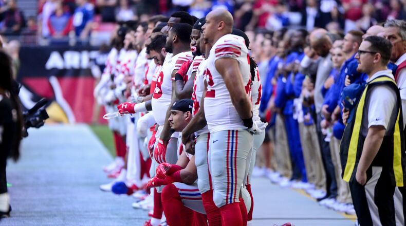 New York Giants defensive end Olivier Vernon (54) kneels during the National Anthem prior to the game against the Arizona Cardinals at University of Phoenix Stadium.