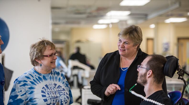 Sarah Morrison (center) talks with Katie McRae, an occupational therapist, and Brett Greenhill, a patient of the Spinal Cord Injury Rehabilitation program at Shepherd Center. Morrison takes over as Shepherd’s CEO and president on Feb. 20. LOUIE FAVORITE