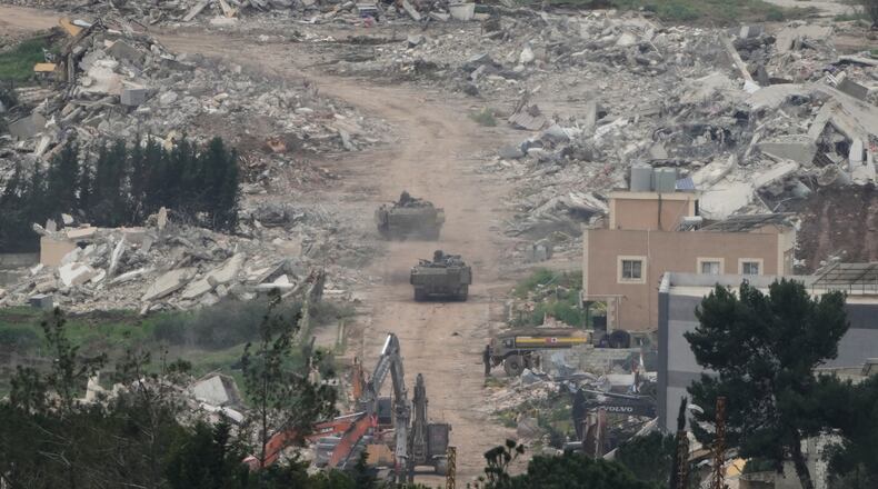 Israeli army vehicles and bulldozers operate in southern Lebanon, as seen from northern Israel, Wednesday, April 15, 2026. (AP Photo/Ariel Schalit)
