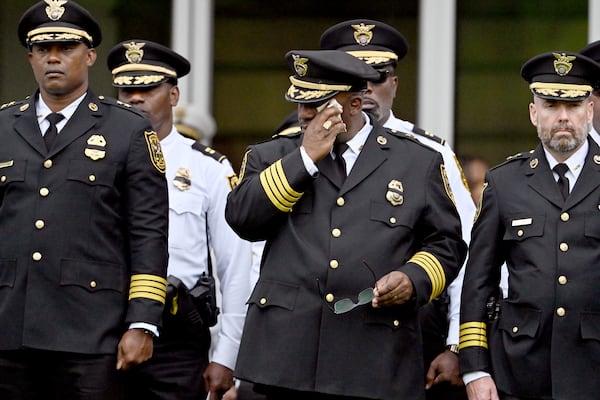 Members of various law enforcement agencies react during the Final Honors following the memorial service for DeKalb County police Officer David Rose, who was killed while responding to the Aug. 8 shooting at the CDC, outside the First Baptist Church Atlanta, Friday, Aug. 22, 2025, in Atlanta. (Hyosub Shin/AJC)