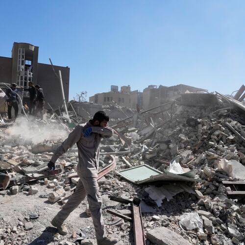 A group of men inspects the ruins of a police station struck Monday amid the U.S.–Israeli military campaign in Tehran, Iran, Tuesday, March 3, 2026. (AP Photo/Vahid Salemi)