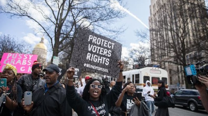 People march during a downtown Atlanta protest Friday. Another march is scheduled for Saturday. BRANDEN CAMP / SPECIAL