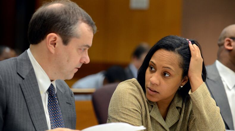 In this file photo, then-Fulton County assistant district attorneys John Floyd and Fani Willis confer as the judge considers the racketeering indictment June 18, 2013, in the Atlanta Public Schools test cheating case. (Photo: Kent D. Johnson/AJC)