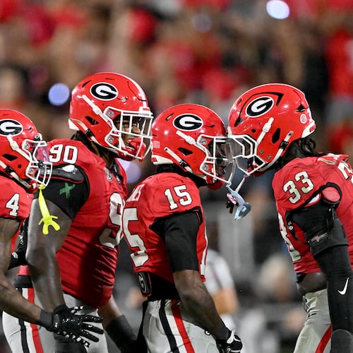 Georgia linebacker Quintavius Johnson (33) celebrates with teammates including defensive back Demello Jones (15) and defensive lineman Elijah Griffin (90) after sacking Alabama quarterback Ty Simpson during the second half in an NCAA football game at Sanford Stadium, Saturday, September 27, 2025, in Athens. Alabama won 24-21 over Georgia. (Hyosub Shin / AJC)