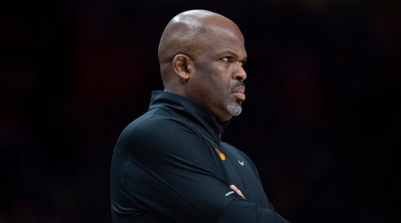 Atlanta Hawks head coach Nate McMillan watching the game during the first half of an NBA basketball game against the New York Knicks Saturday, Nov. 27, 2021, in Atlanta. (AP Photo/Hakim Wright Sr.)