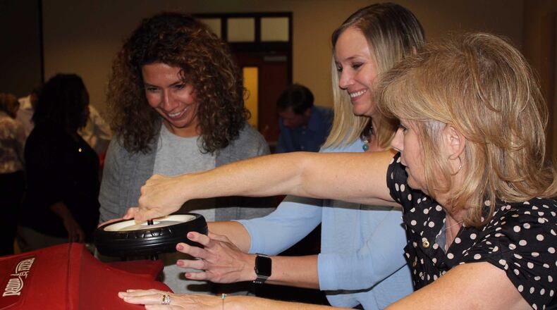Cobb EMC employees spent some of their Valentine's Day 2017 constructing 30 red IV pole wagons for sick children at Children’s Healthcare of Atlanta at Scottish Rite.