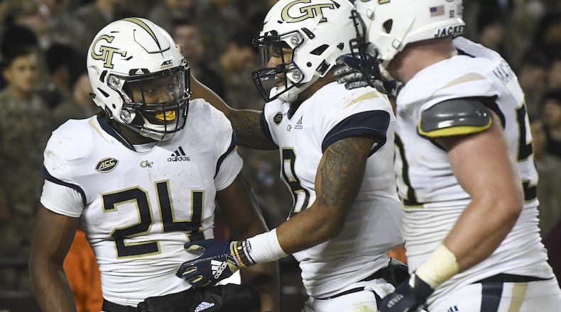 BLACKSBURG, VA - OCTOBER 25: Running back Jordan Mason #24 of the Georgia Tech Yellow Jackets celebrates his touchdown run against the Virginia Tech Hokies with quarterback Tobias Oliver #8 in the second half at Lane Stadium on October 25, 2018 in Blacksburg, Virginia. (Photo by Michael Shroyer/Getty Images)