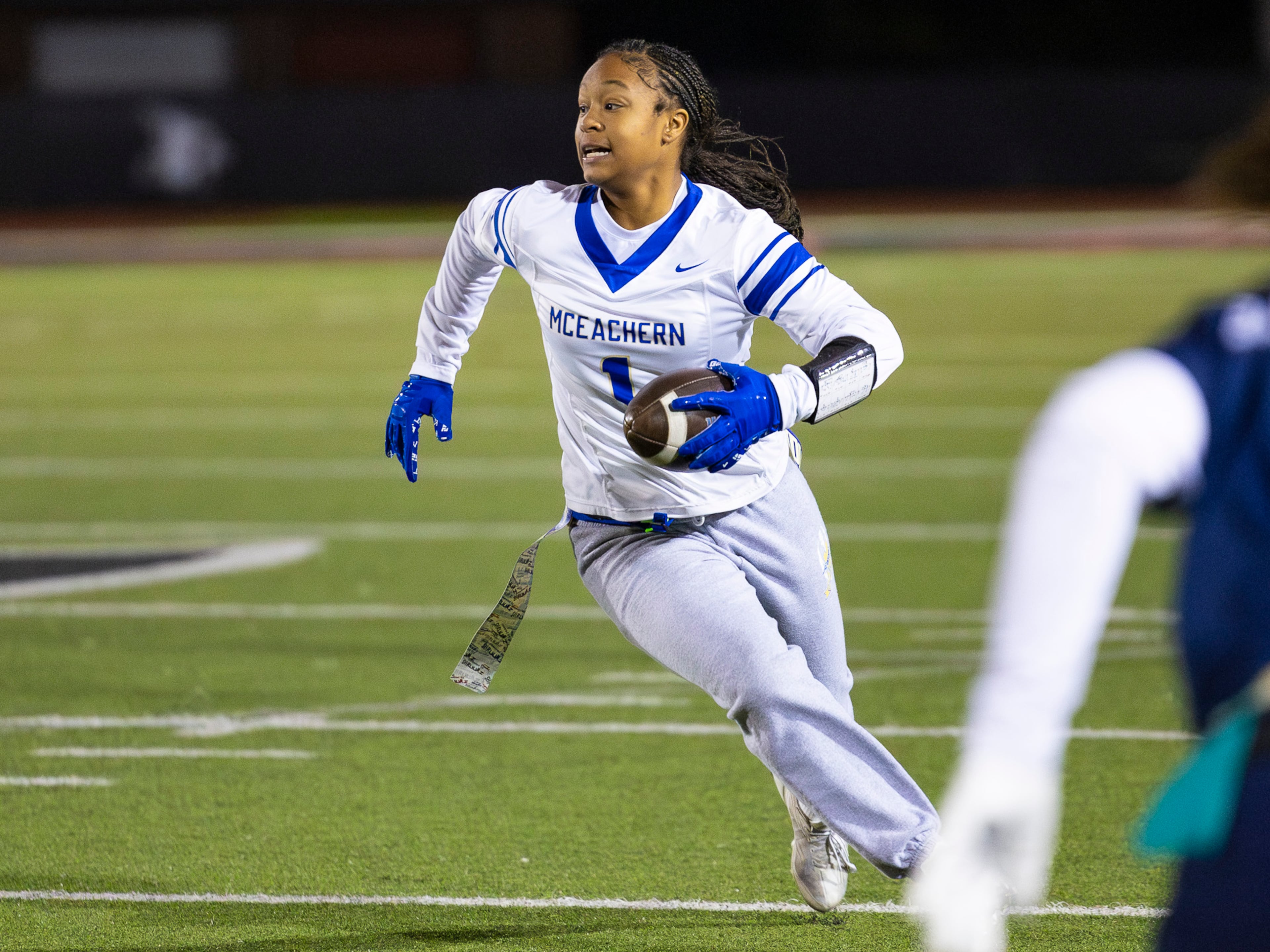 McEachern wide receiver Michala Butler (1) runs with the ball in a flag football game against Marietta at Osborne High School in Marietta, GA on Monday, November 17th, 2025. (Oscar Guevara Saenz for the AJC)