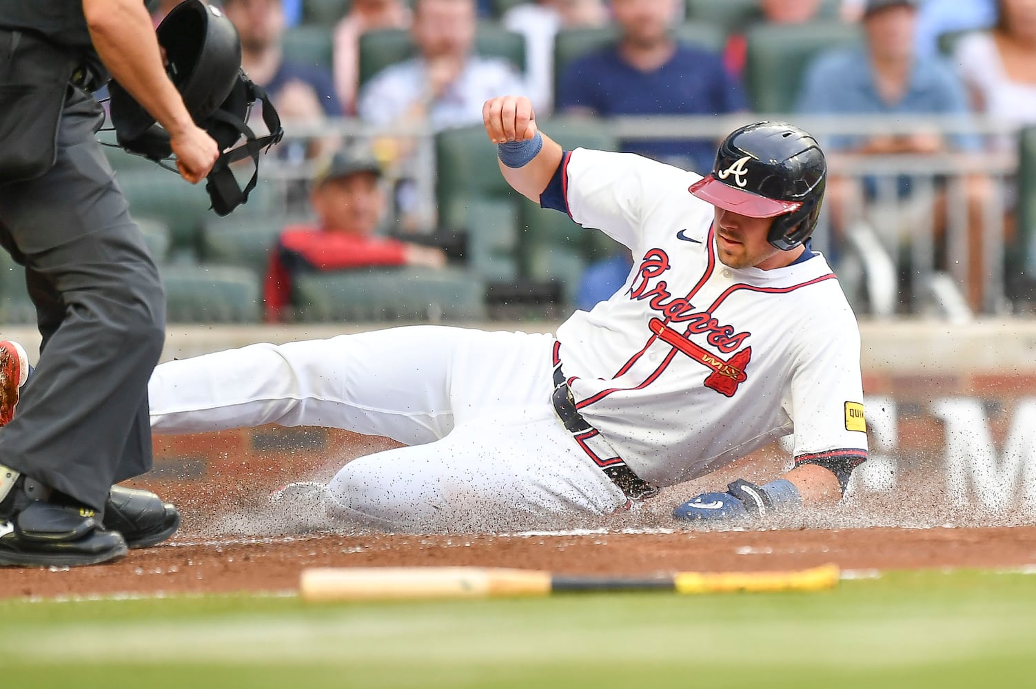 Atlanta Braves third baseman Austin Riley (27) slides safely into home plate on a sacrifice fly ball by designated hitter Marcell Ozuna (20) in the first inning of a MLB game Wednesday, June 18, 2025 at Truist Park. (Daniel Varnado/For the Atlanta Journal-Constitution)