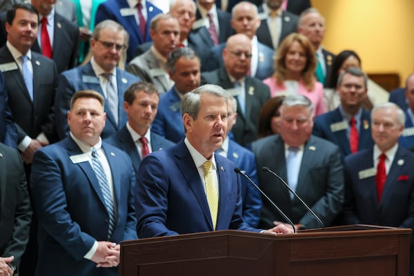 Gov. Brian Kemp (center) speaks during the signing of numerous bills at the Capitol in April. (Jason Getz/AJC)
