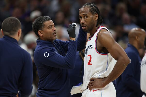 Los Angeles Clippers forward Kawhi Leonard (2) get looked at by the medics during second half of an NBA basketball game against theSacramento Kings, Friday, April 11, 2025, in Sacramento, Calif. (AP Photo/Scott Marshall)