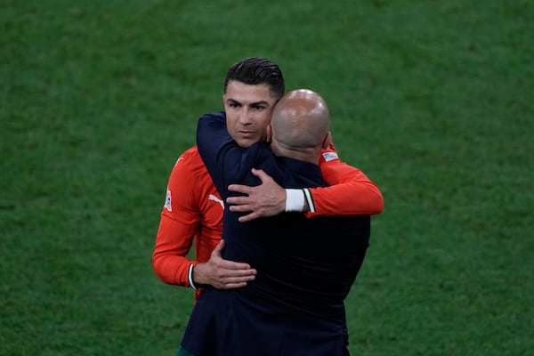 Portugal's Cristiano Ronaldo, left, embraces to Portugal coach Roberto Martinez during the Nations League final soccer match between Portugal and Spain at the Allianz Arena in Munich, Germany, Sunday, June 8, 2025. (AP Photo/Michael Probst)