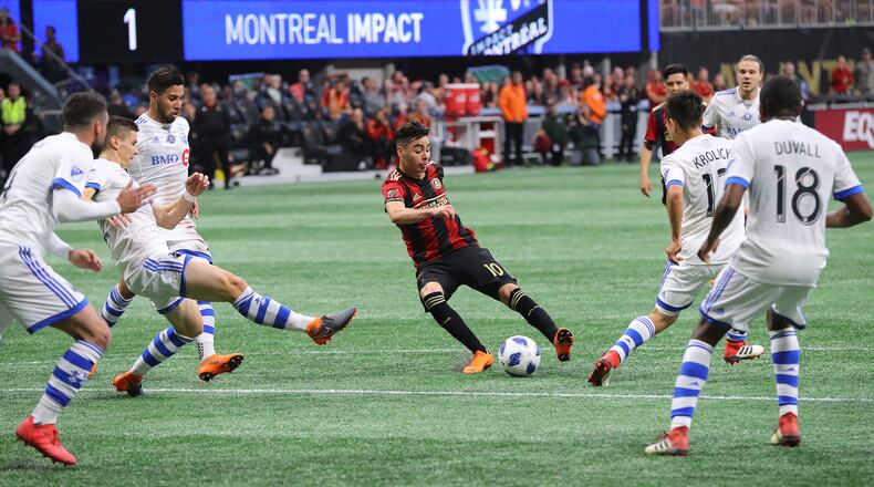 Atlanta United midfielder Miguel Almiron works the ball for a shot on goal against five Montreal Impact defenders during the first half in a MLS soccer game on Saturday, April 28, 2018, in Atlanta. Curtis Compton/ccompton@ajc.com