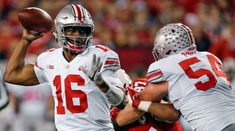 Ohio State quarterback J.T. Barrett (16) throws as offensive lineman Billy Price (54) blocks Nebraska defensive lineman Deontre Thomas (97) during the first half of an NCAA college football game in Lincoln, Neb., Saturday, Oct. 14, 2017. (AP Photo/Nati Harnik)