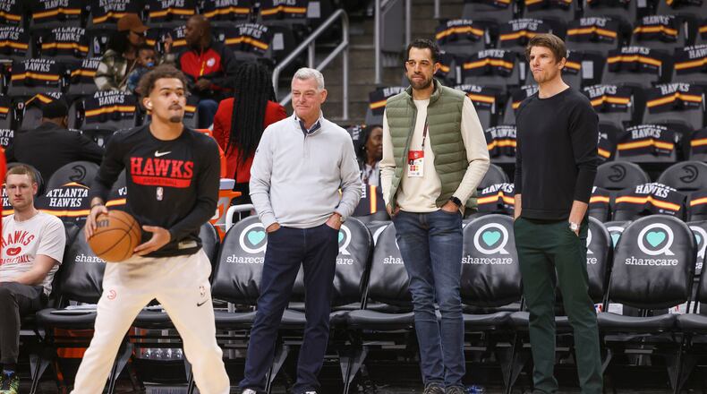 Atlanta Hawks guard Trae Young prepares to shoot while (from left) Hawks owner Tony Ressler, general manager Landry Fields and assistant GM Kyle Korver watch before the Hawks' game against the Cleveland Cavaliers at State Farm Arena, Friday, Feb. 24, 2023, in Atlanta. (Jason Getz/The Atlanta Journal-Constitution/TNS)