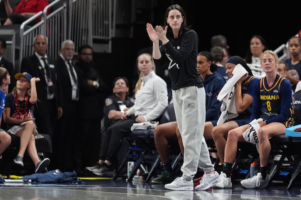 Indiana Fever's Caitlin Clark cheers during the first half of a WNBA basketball game against the Las Vegas Aces, Thursday, July 3, 2025, in Indianapolis. (AP Photo/Michael Conroy)