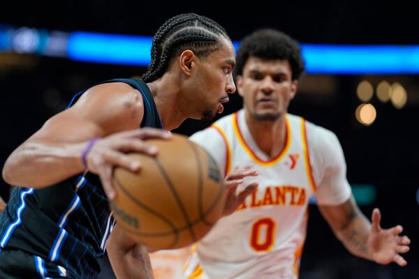Orlando Magic guard Jett Howard (13) drives against Atlanta Hawks forward Dominick Barlow (0) during the first half of an NBA basketball game, Sunday, April 13, 2025, in Atlanta. (AP Photo/Mike Stewart)