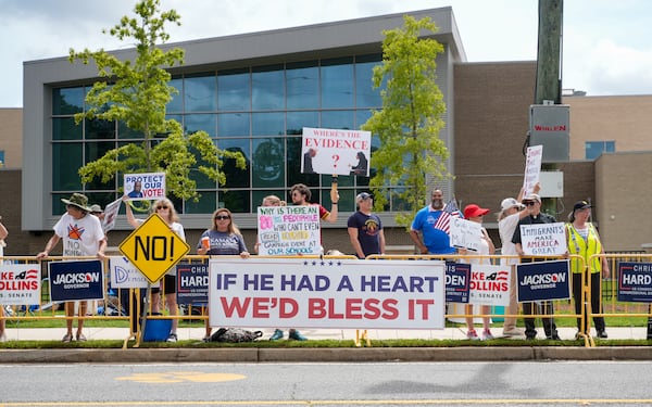 Protestors gather in Marietta while waiting for President Donald Trump to speak at Wheeler High School on Wednesday. (Ben Hendren for the AJC)