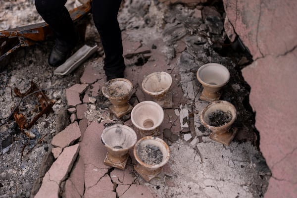 Florist Renata Ortega walks past ceramics she salvaged after the Eaton Fire, in Altadena, Calif., Saturday, March 29, 2025. (AP Photo/Jae C. Hong)