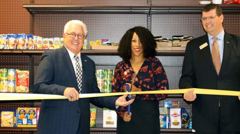 Participating in the recent opening of the 30th school food pantry were (l-r) MUST Ministries President and CEO Dr. Dwight “Ike” Reighard, Garrett Middle School Principal Kimberly Jackson and Drew Shambarger, chairman of the MUST Ministries Board of Directors and the Market President for BB&T Northwest Atlanta. Courtesy of the Cobb County School District