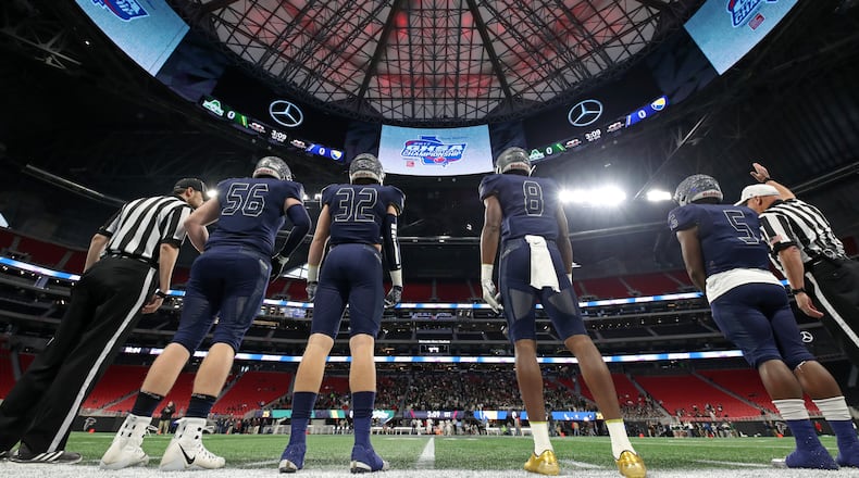 Eagle's Landing Christian captains Zack Jones (56), George Shockley (32), Tre' Douglas (8) and Josh Mays (5) lines up for the coin toss before their game against Athens Academy during the Class A Private Championship at Mercedes-Benz Stadium Friday, December 8, 2017 in Atlanta.