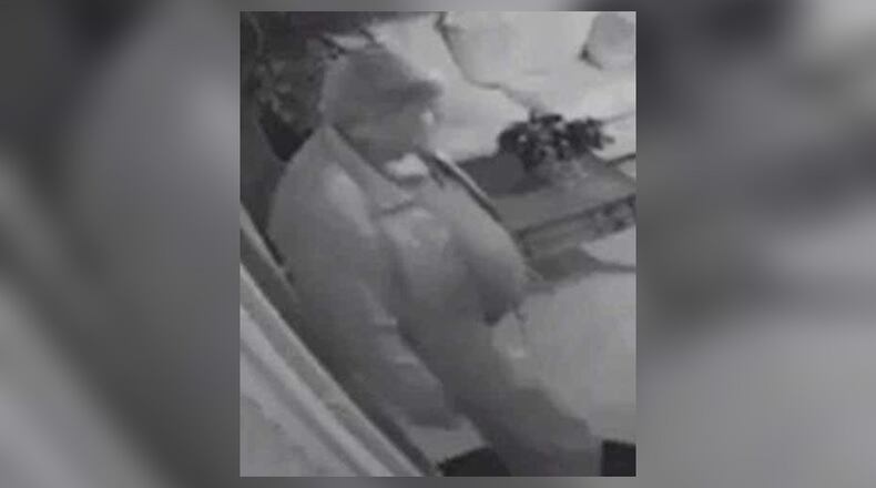 Investigators need the public's help to identify a man accused of posing as a cop at a Roswell massage parlor.