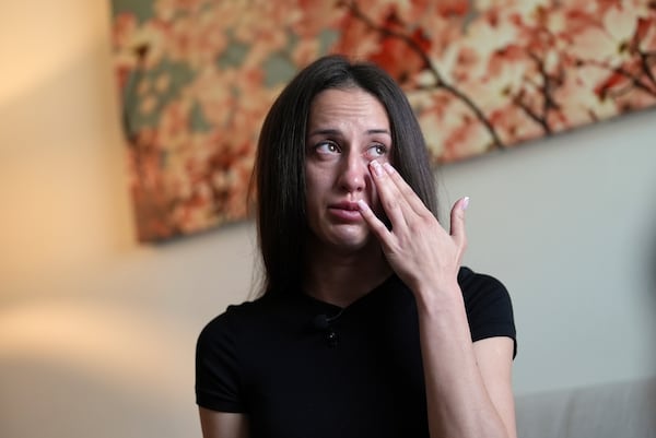 Oksana Tarasiuk wipes away tears as she talks about her husband, Maksym Chernyak, who died in ICE custody after being held in Krome Detention Center, at the couple's apartment in Hallandale Beach, Fla., Tuesday, April 22, 2025. (AP Photo/Rebecca Blackwell)