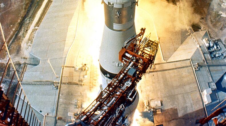 At 9:32 a.m. EDT, the swing arms move away and a plume of flame signals the liftoff of the Apollo 11 Saturn V space vehicle and astronauts Neil A. Armstrong, Michael Collins and Edwin E. Aldrin, Jr. from Kennedy Space Center Launch Complex 39A. (Courtesy NASA)